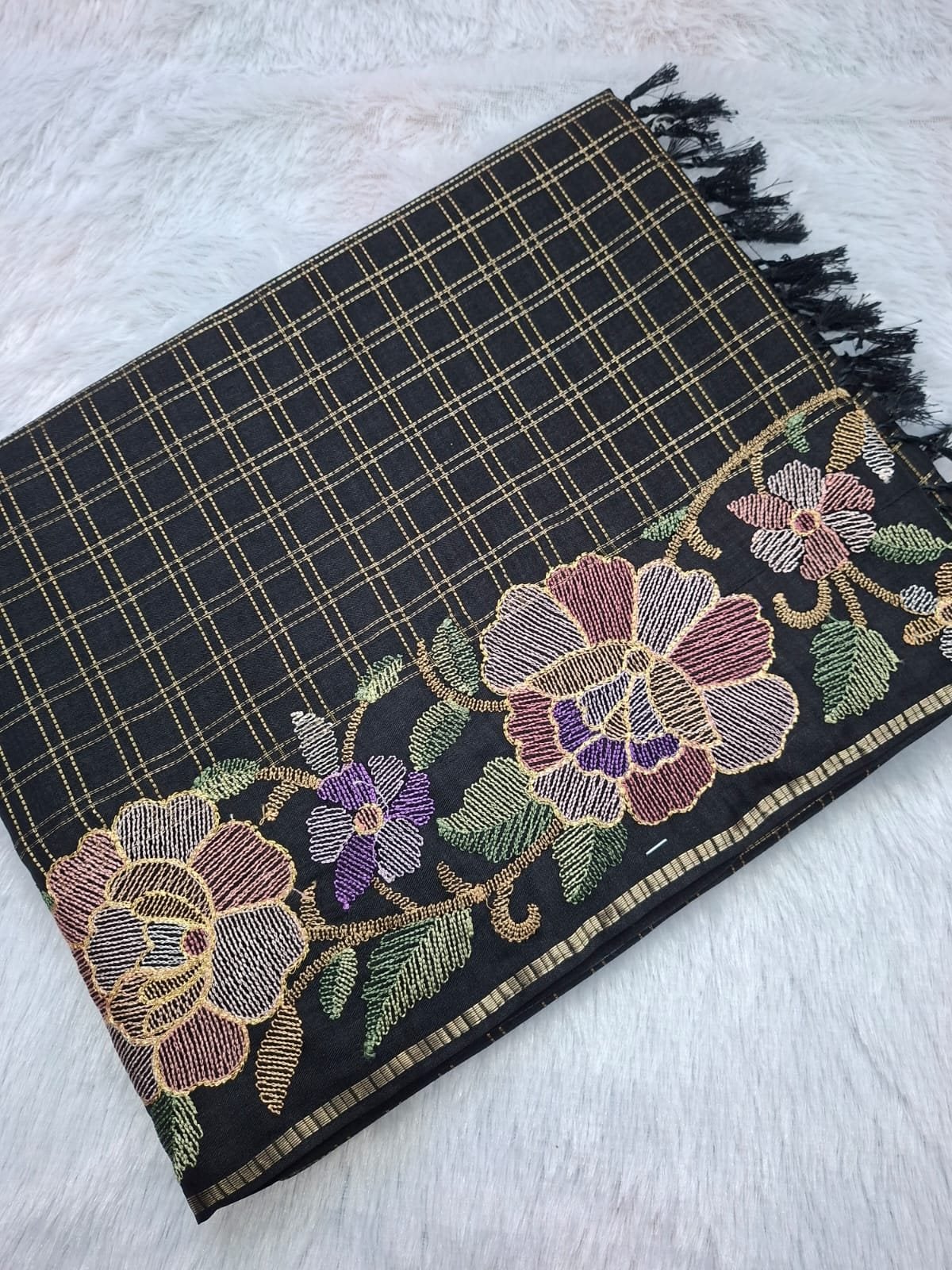 Black viscose tussar saree with floral checks, folded