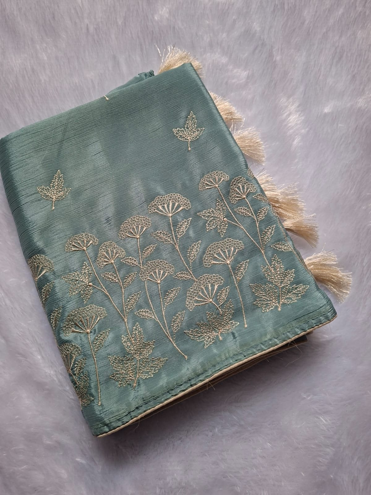 Dusty Blue thread embroidery saree with tassels, folded
