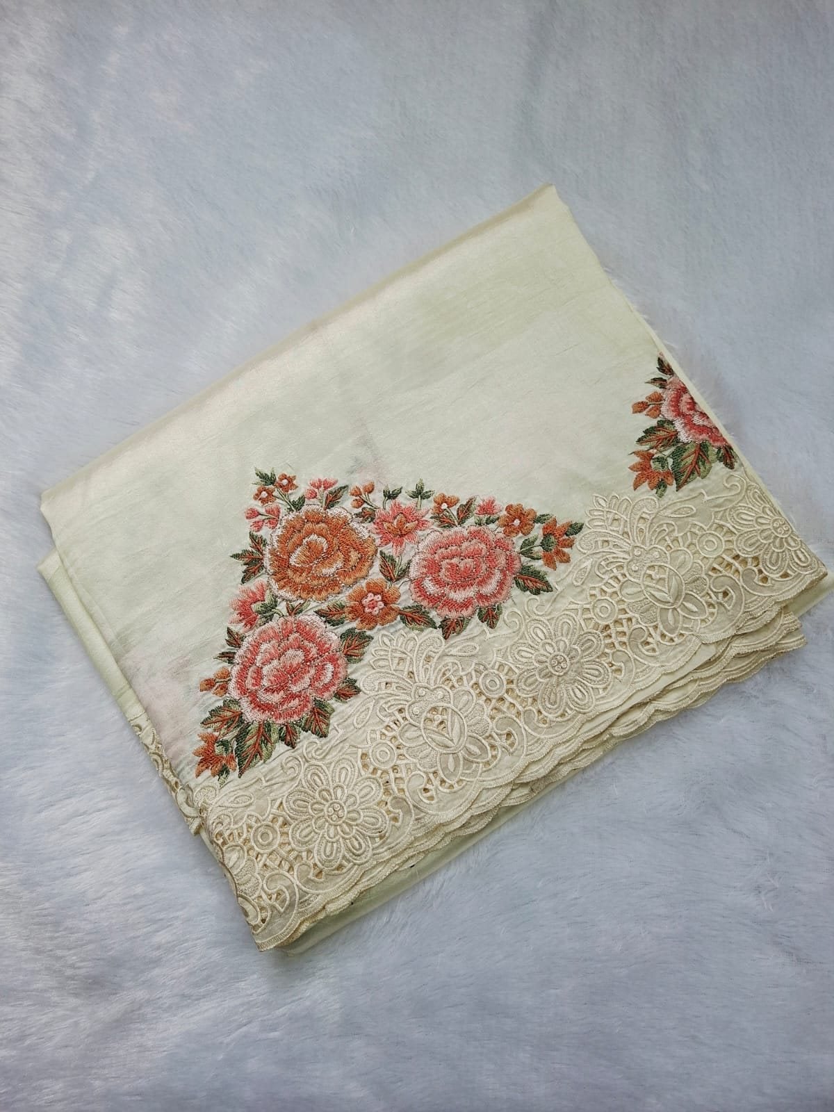 Ivory pure raw silk saree with rose embroidery and cut-work border, folded