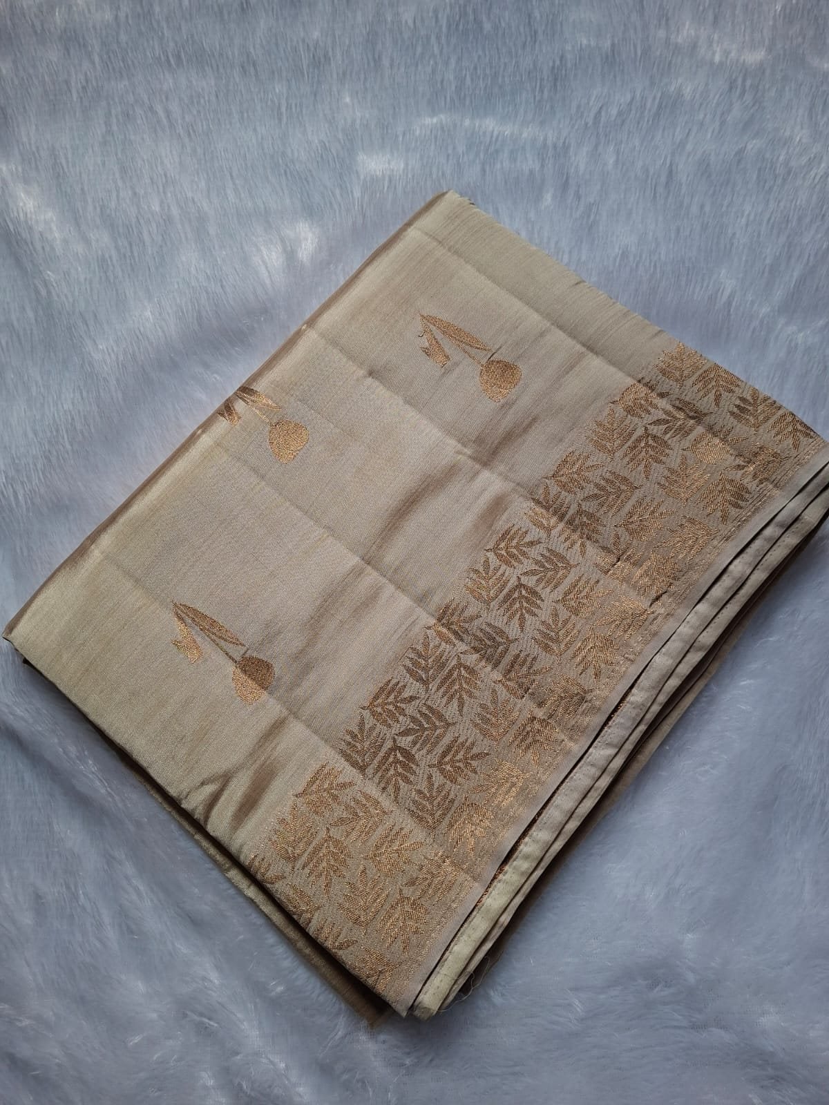 Ivory semi raw silk saree with rich zari, folded