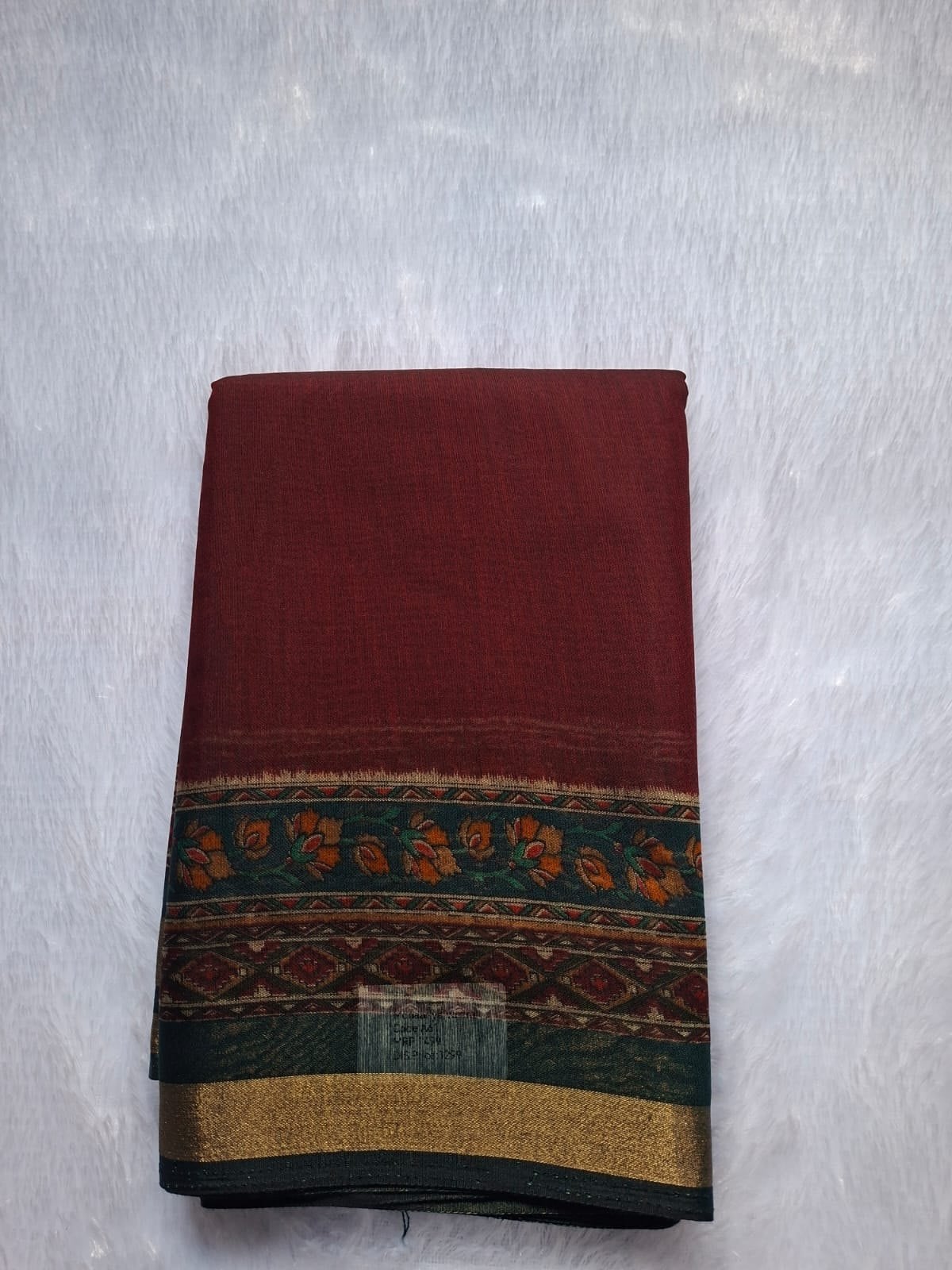 Maroon cotton blend saree, folded to show the body and border