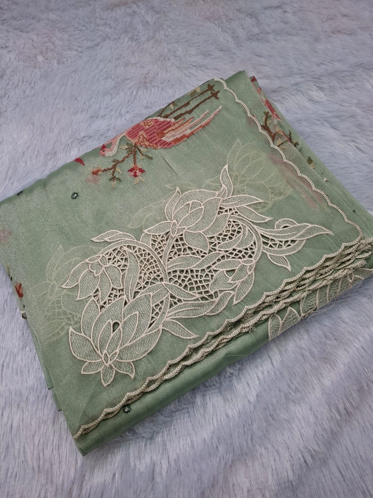 Mint pure tissue saree with lotus cut work and cross-stitch, folded