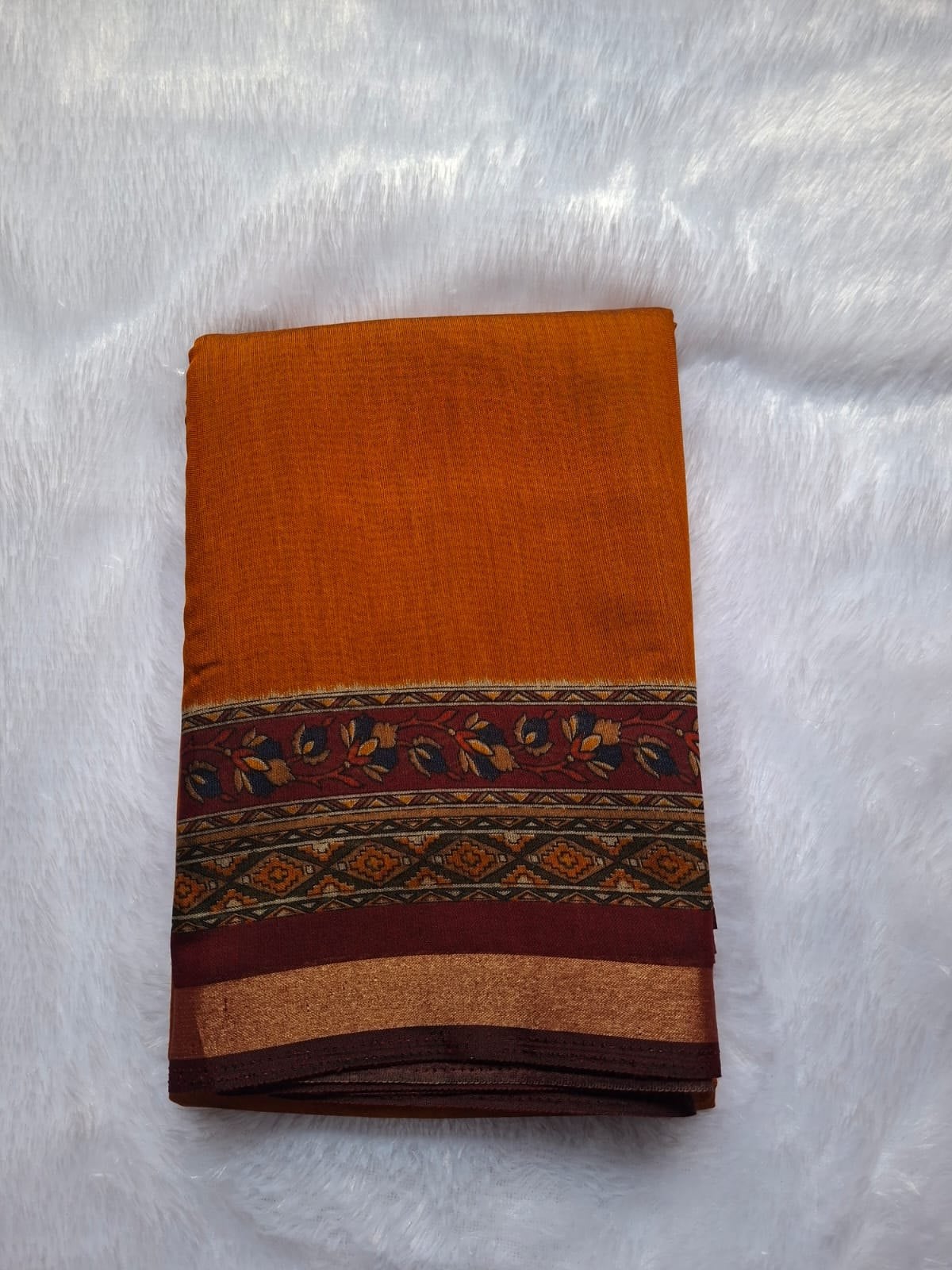 Mustard cotton blend saree, folded to show the body and border