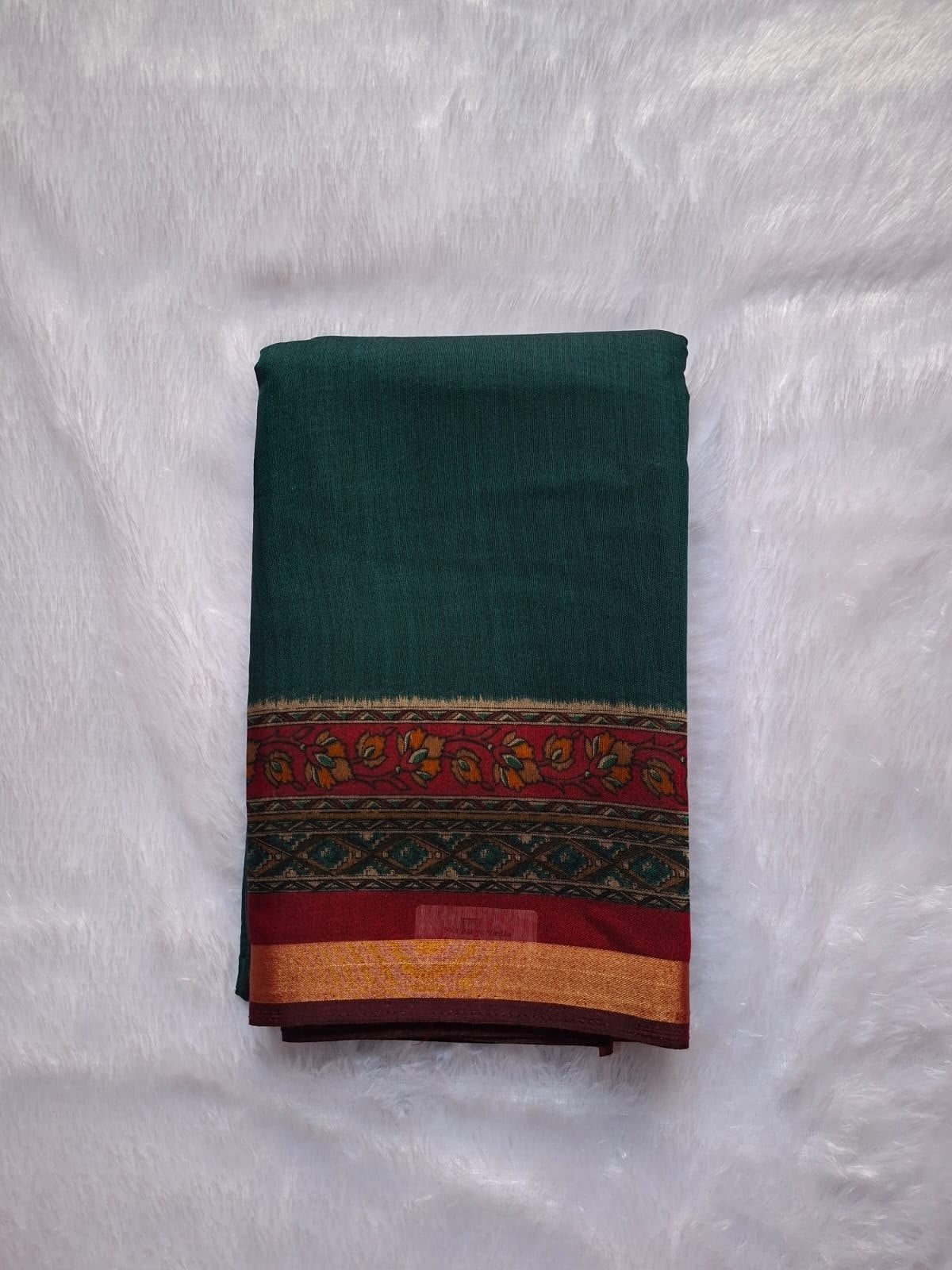 Teal Green cotton blend saree, folded to show the body and border