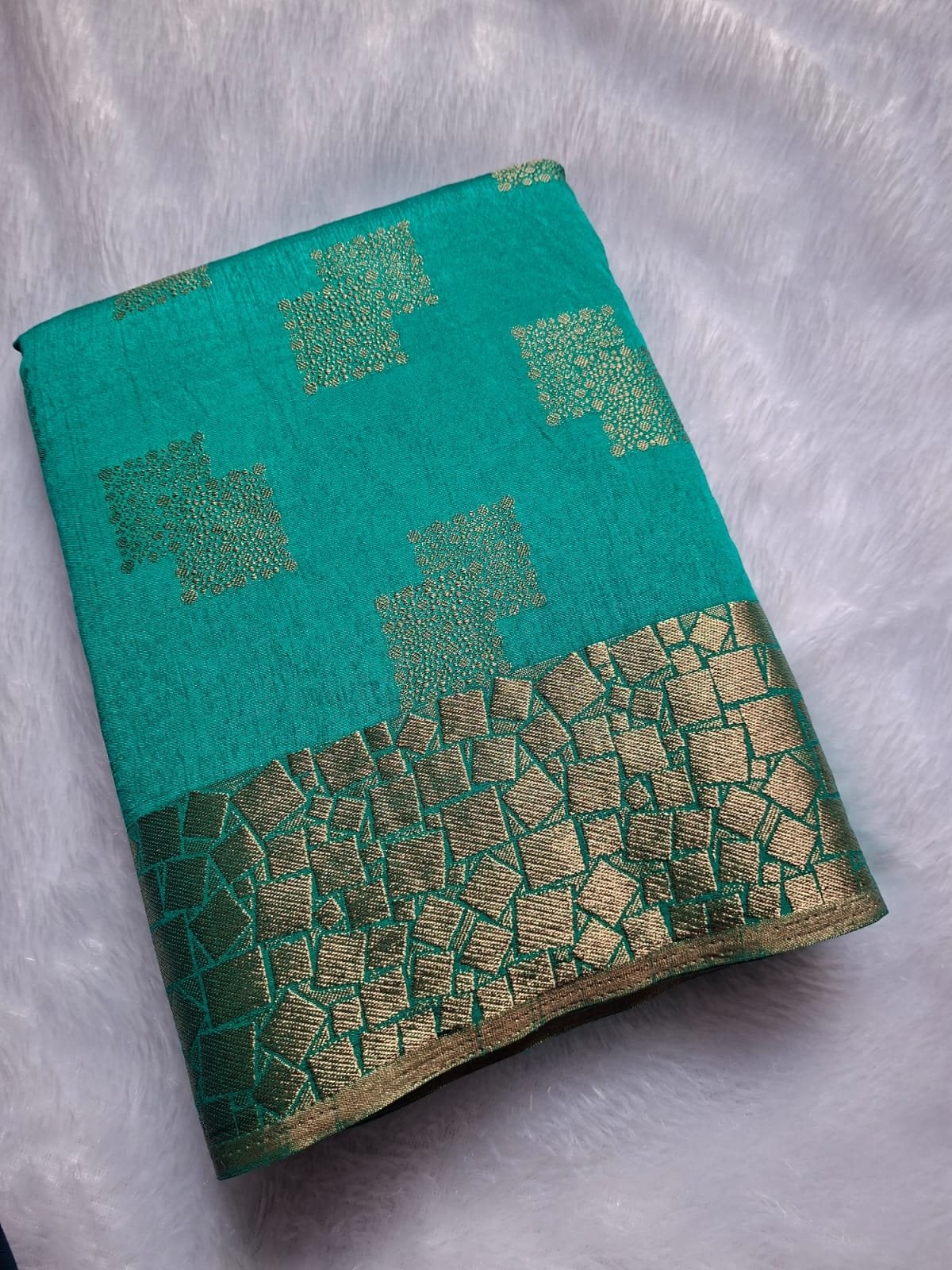 Turquoise semi silk saree, folded