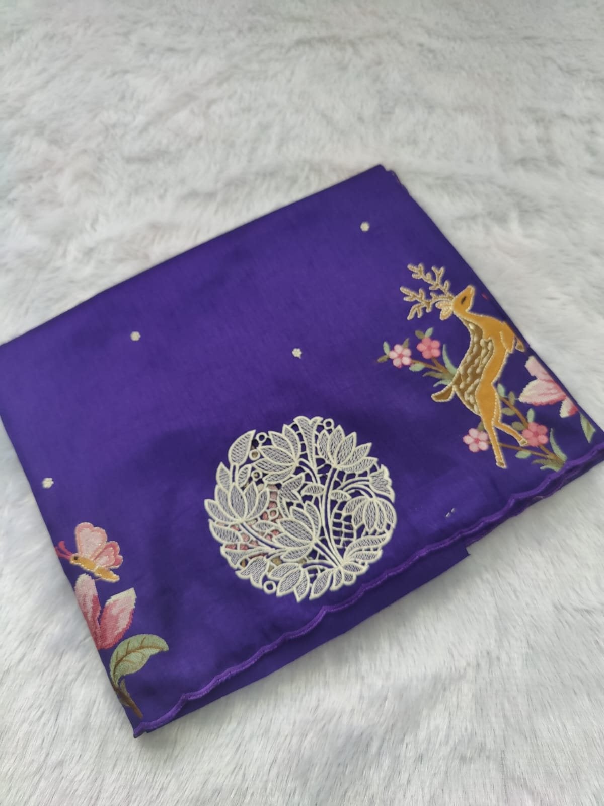 Violet pure raw silk saree with cut-work medallion and embroidered deer, folded
